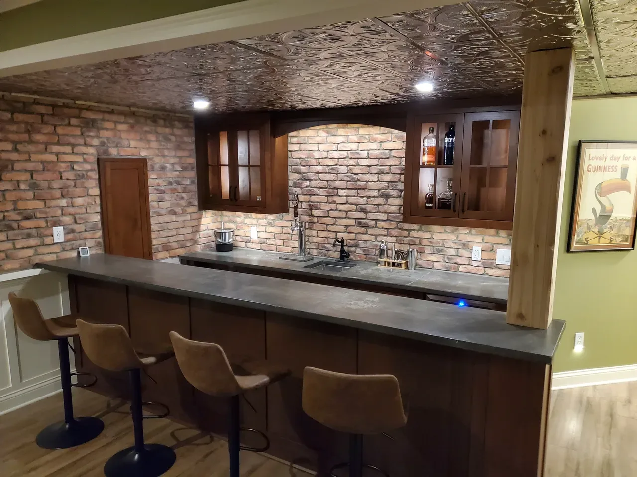 Custom wood basement bar with brick backsplash and bar seating