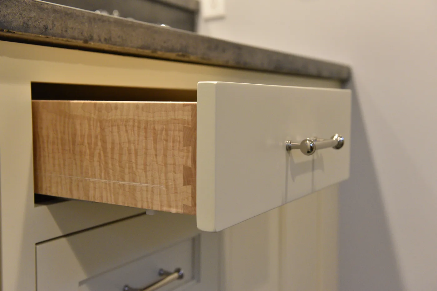 Hand-cut dovetail drawer joint in figured maple — Wildwater craftsmanship