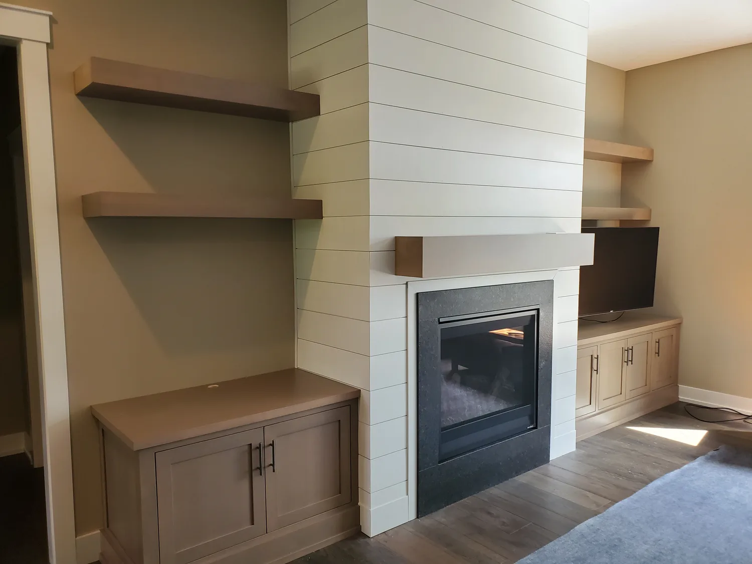Modern fireplace built-in with floating shelves and shiplap