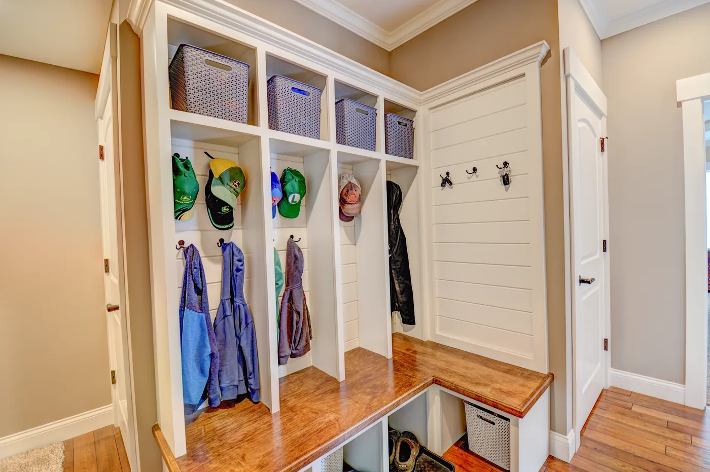 White mudroom lockers with a wood bench