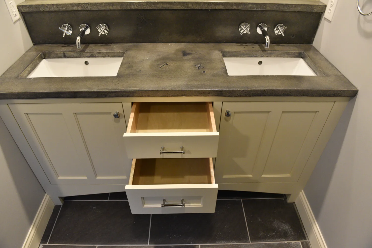 Double bathroom vanity with integrated concrete sinks and dovetail drawers