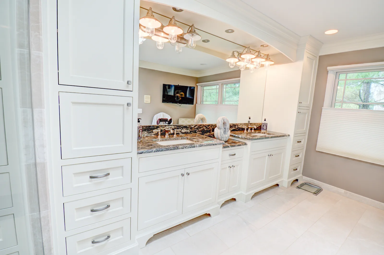 Master bath vanity with granite tops and a linen tower